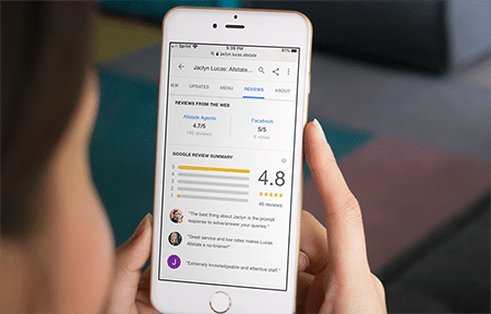 Mobile phone displaying google reviews for business